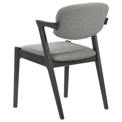 Set of two black Stevie padded wood dining arm chairs with armrests and cushioned seats, designed for modern dining rooms.
