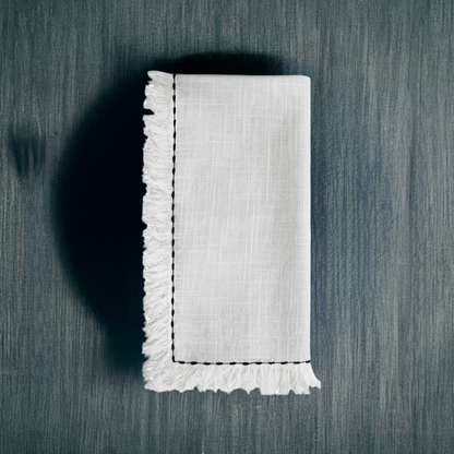 Set of four Start2Finish home table cloth napkins with elegant black embroidery, showcasing detailed stitching and soft fabric.