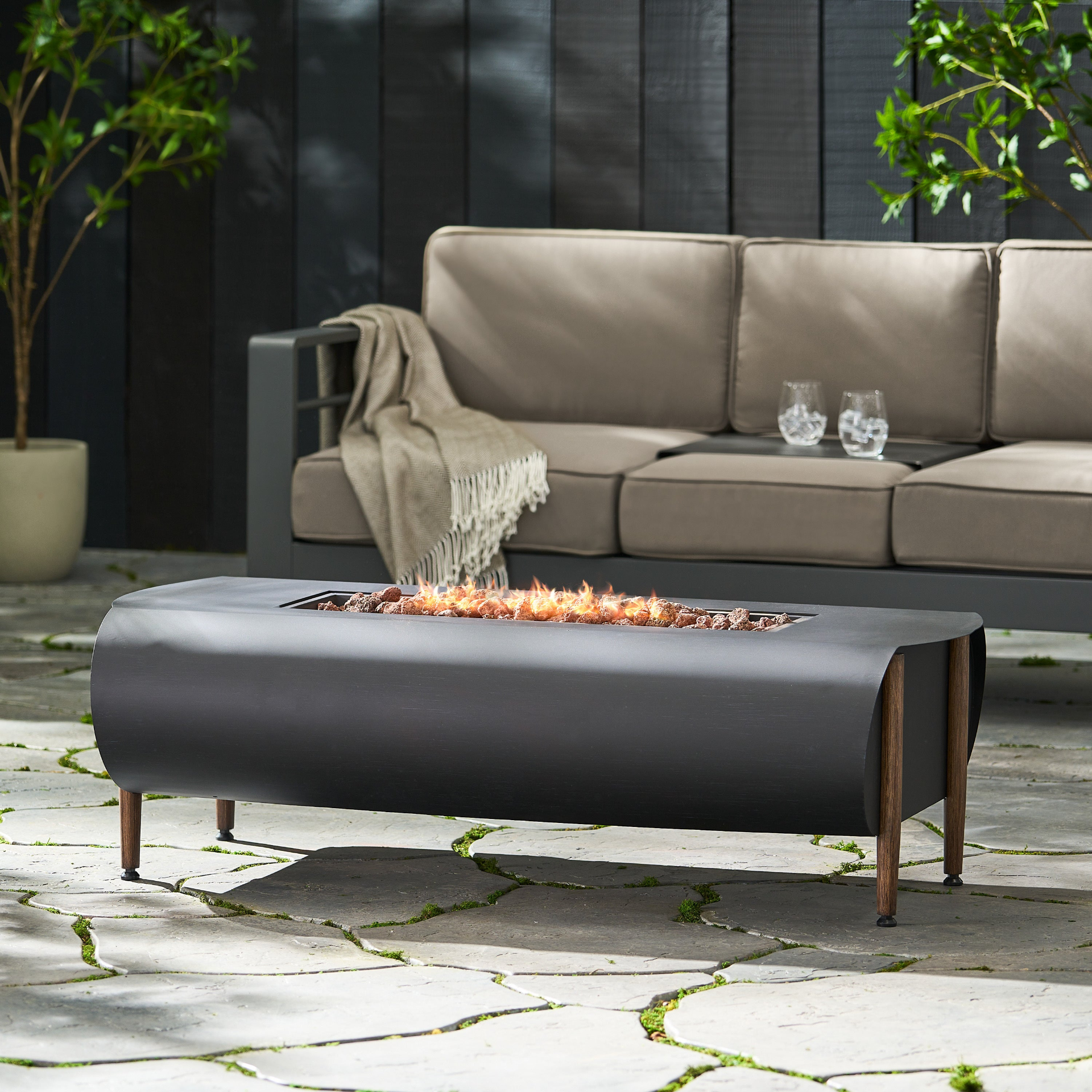 Dark gray iron fire pit table with tank holder, perfect for patio and outdoor living spaces by Start2Finish.