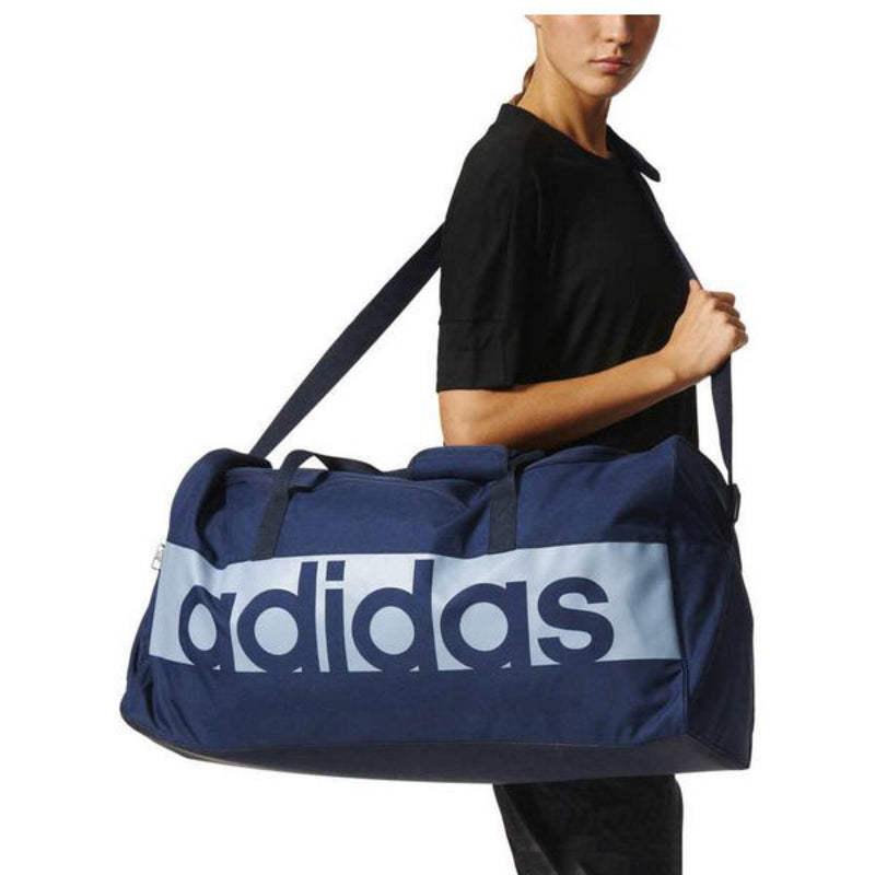 Adidas Lin Per TB M sports bag in black with white logo, large main compartment and adjustable shoulder strap for outdoor activities.