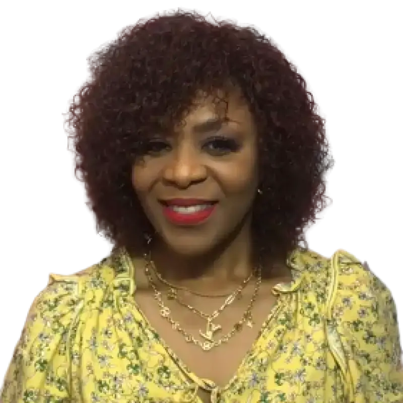Peach Clymene Kelly curly human hair wig with bangs, full volume, showcasing glossy, styled hair with soft curls and layered bangs.