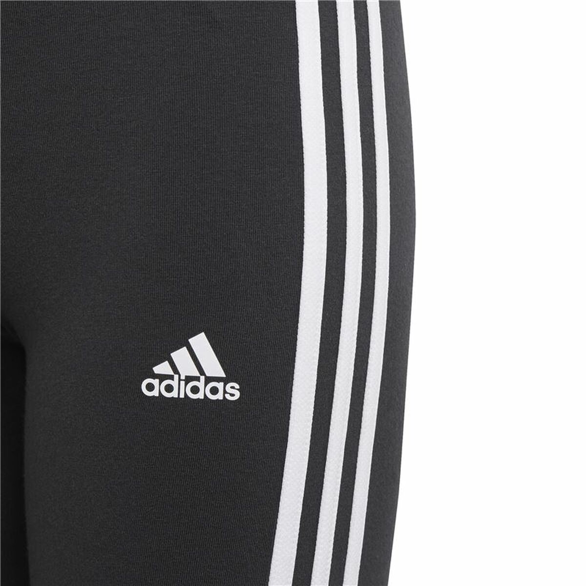 Black Adidas Essentials sports leggings with three white stripes, designed for activewear and outdoor activities.