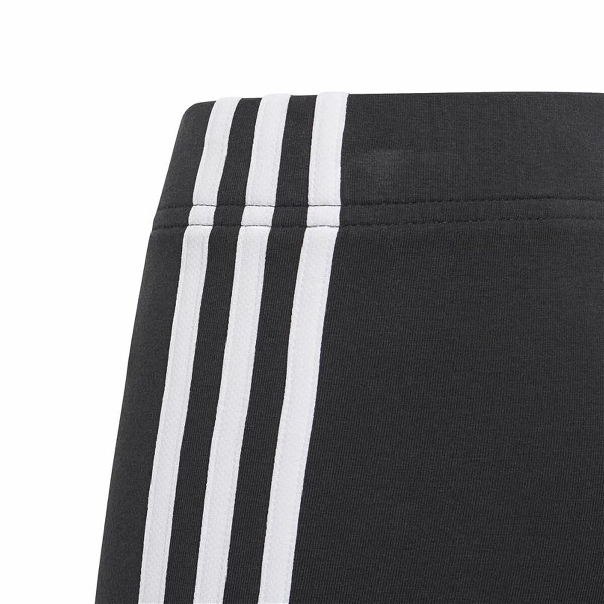 Black Adidas Essentials sports leggings with 3 stripes, designed for active wear and outdoor sports activities.