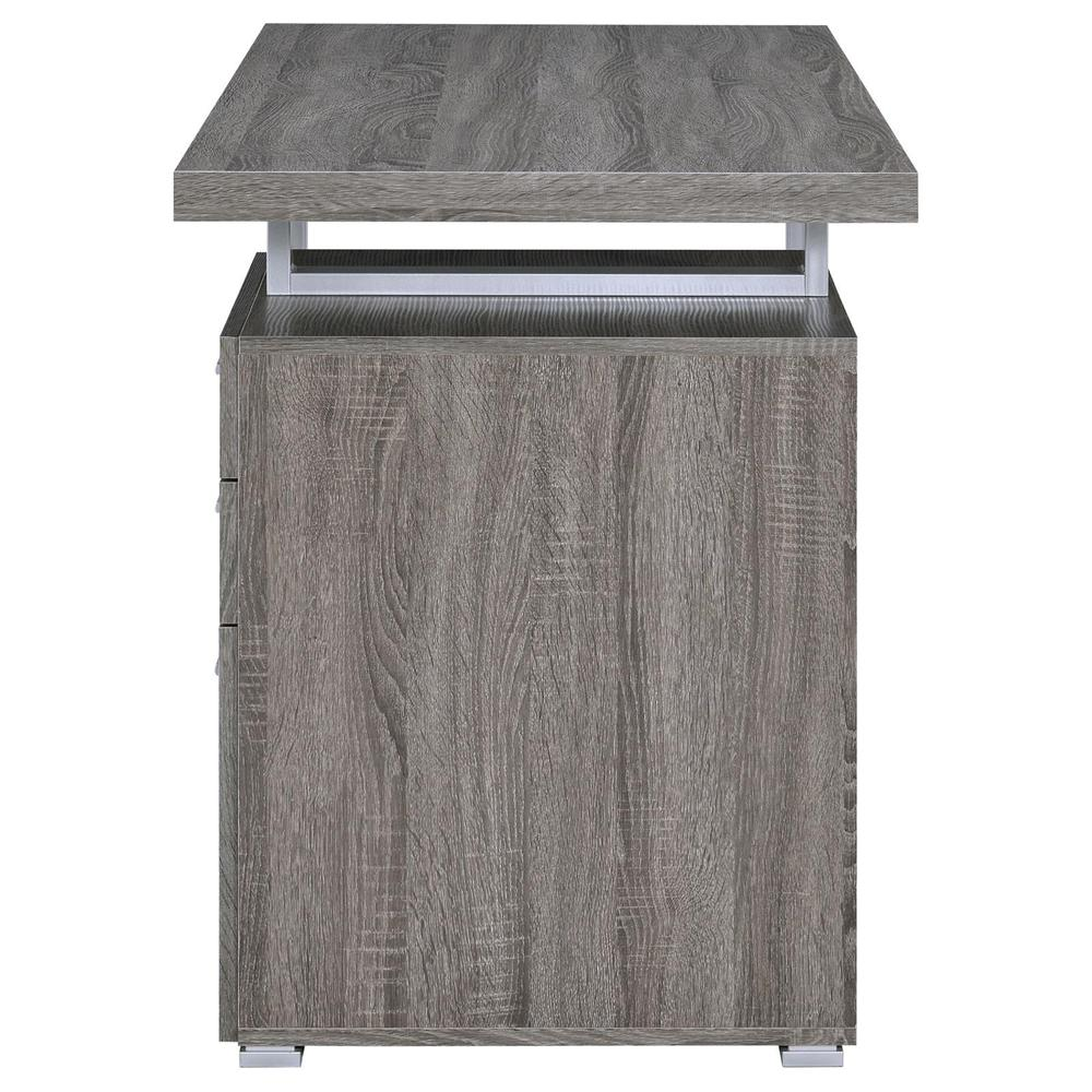 Weathered grey Brennan 47-inch office computer desk with three drawers by Start2Finish, shown from front with smooth surface and storage drawers.