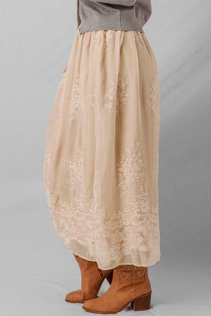 Solid embroidered mesh overlay midi skirt for women by Byzantium Bay, featuring intricate embroidery and flowy design.