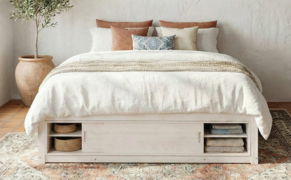 Solid wood platform bed frame with four storage drawers, footboard cubby, and headboard, ideal for bedroom or guest room.