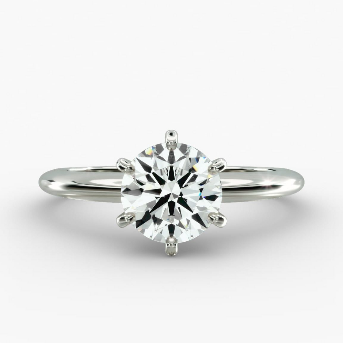 Round lab-grown diamond solitaire engagement ring with six prongs, F-VS clarity, set in 14K white gold.
