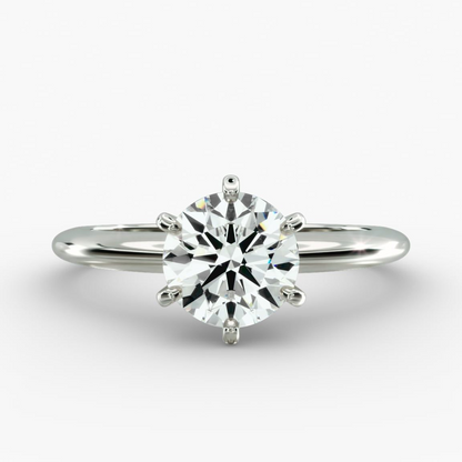 Round lab-grown diamond solitaire engagement ring with six prongs, F-VS clarity, set in 14K white gold.