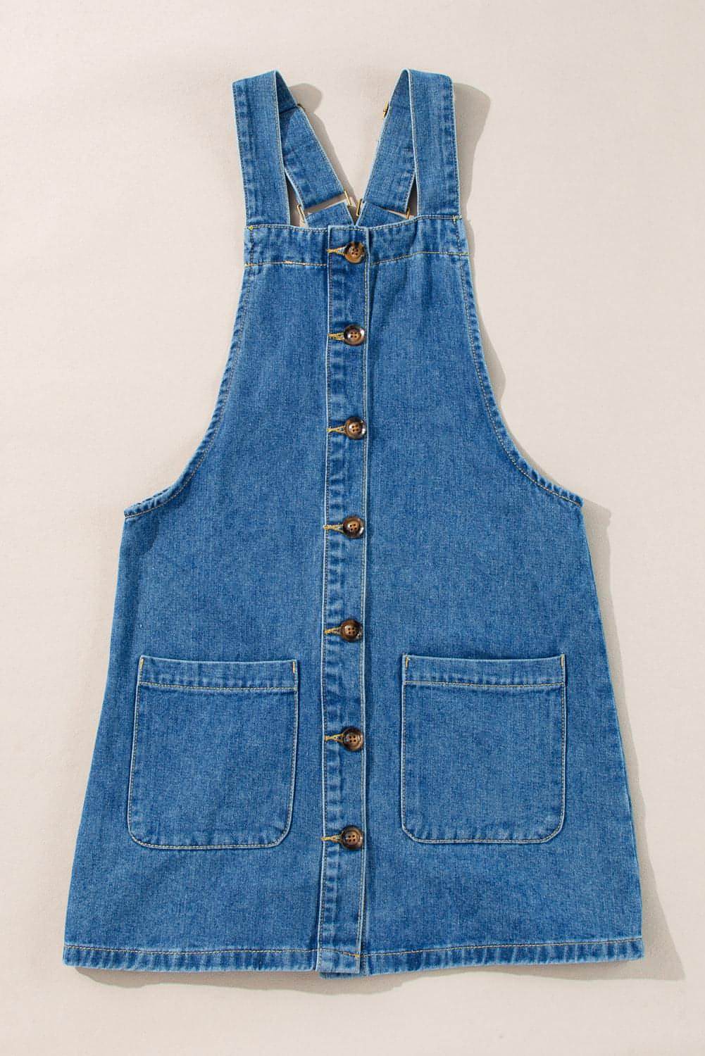Dusk blue Carmine Juneberry denim mini dress with wide straps, button front, and front pocket details.