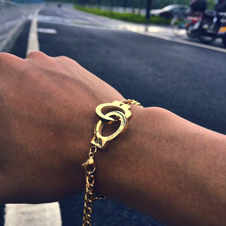 Fuchsia Molly handcuffs bracelet featuring silver-toned metal links and adjustable chain detail.