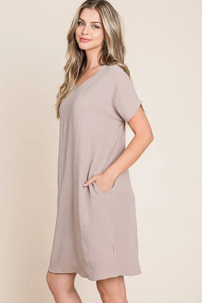 Jade Icarus BOMBOM V-neck short sleeve dress with pockets, showcasing a stylish automotive-inspired design in a vibrant color.