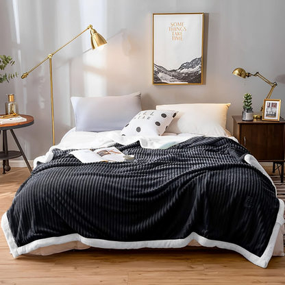 Start2Finish SOGA 2X black throw blanket draped over a sofa, showcasing cozy, soft home textile with subtle texture and edges.