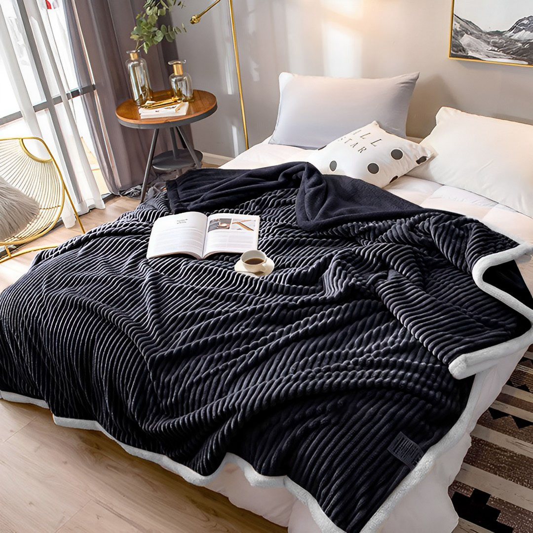Black SOGA throw blanket by Start2Finish, soft and cozy home accessory draped over a sofa in a modern living room