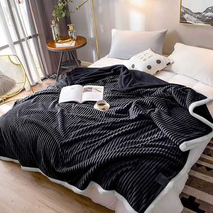 Black SOGA throw blanket by Start2Finish, soft and cozy home accessory draped over a sofa in a modern living room