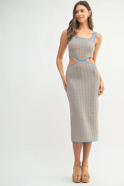 Multi-color chevron knit bodycon midi dress by Pear Daisy, shown on a model with a fitted silhouette and vibrant pattern.