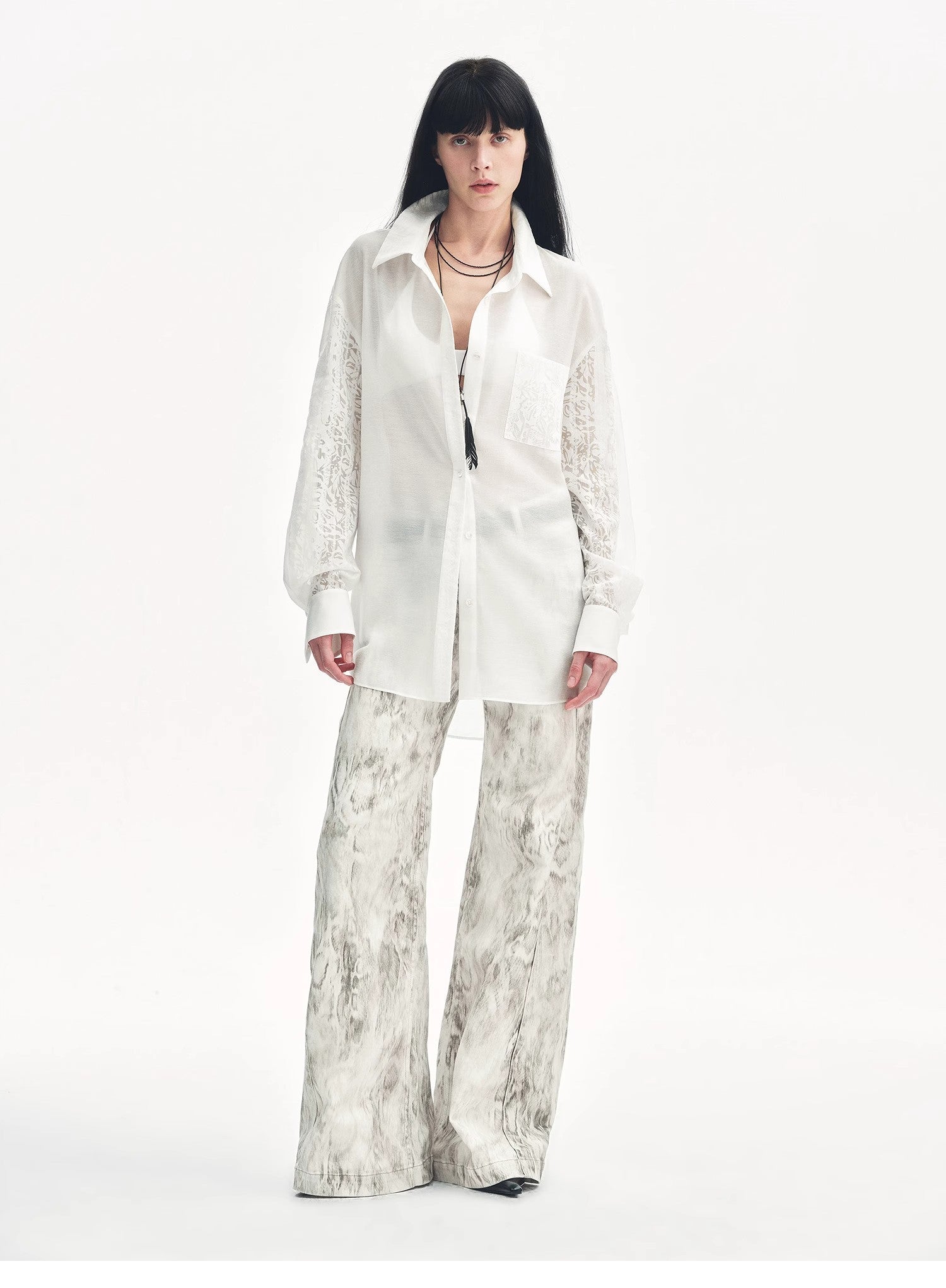 Snake print flared denim trousers by Brown Coeus, featuring a stylish "Phantom" design with a fitted waist and flared leg silhouette.
