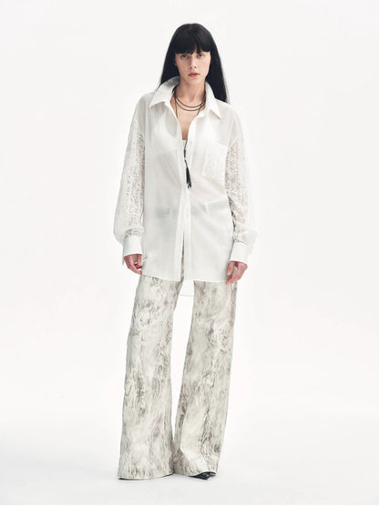 Snake print flared denim trousers by Brown Coeus, featuring a stylish "Phantom" design with a fitted waist and flared leg silhouette.