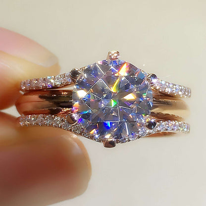 Pair of 18K gold moissanite rings from Carmine Juneberry, showcasing elegant design and sparkling gemstones.