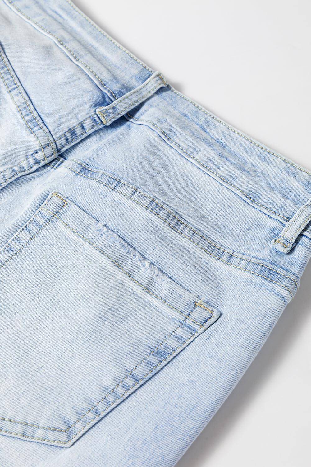 Beau Blue vintage light wash distressed flare jeans by Carmine Juneberry, showcasing a high-waisted fit and frayed hem details.