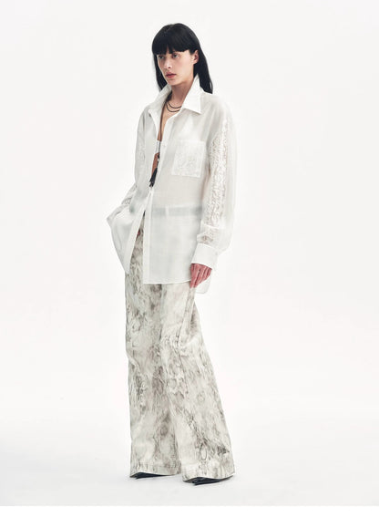 Brown Coeus Phantom snake print flared denim trousers, showcasing their unique snake pattern and high-waisted flare design.