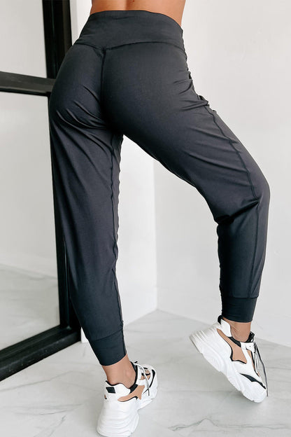 Black exposed seam high waist joggers with pockets by Carmine Juneberry, featuring a stylish, comfortable fit and modern design.