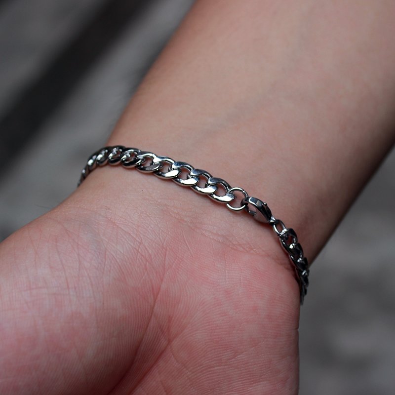 Personalized steel chain bracelet by Fuchsia Molly with custom engraving on a sleek silver-toned metal chain.