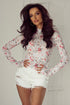 Pink floral long sleeve high neck sheath mesh top by Carmine Juneberry, featuring a fitted design and delicate floral pattern.