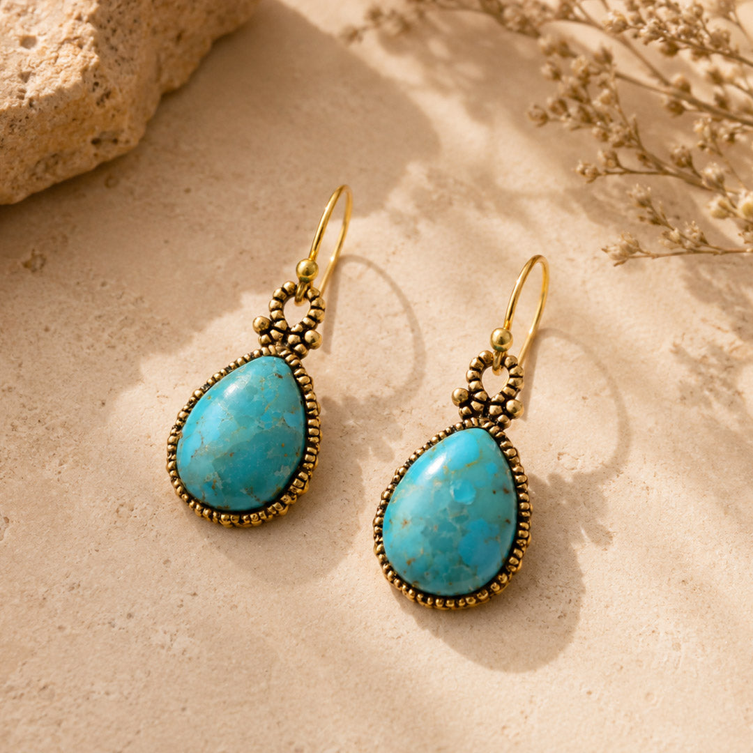 Blue turquoise and golden jewelry earrings with dreamy drop design, featuring intricate details and a polished finish.