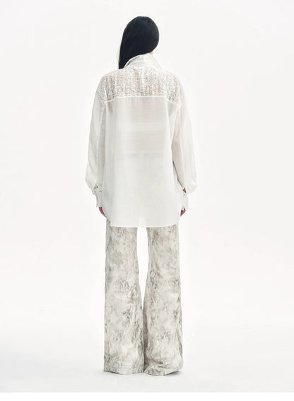 Brown Coeus Phantom snake print flared denim trousers with a stylish, fitted design and unique snake pattern.
