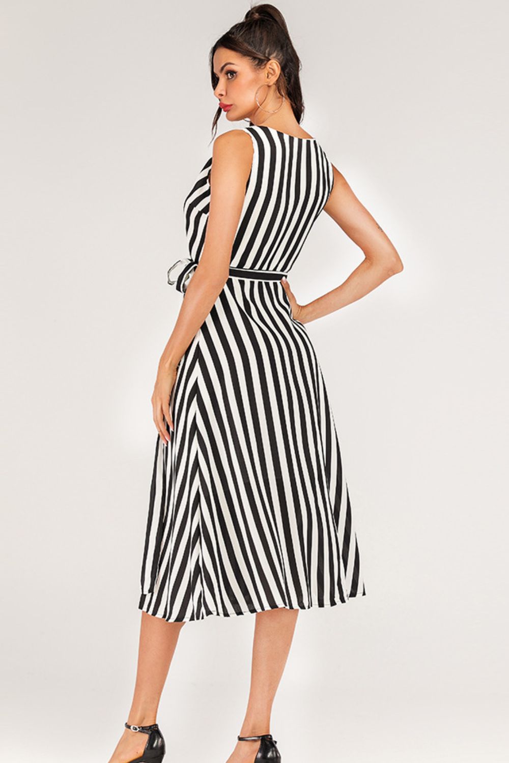 Pear Daisy striped surplice tied sleeveless dress, casual summer dress with tie details and bold stripe pattern, perfect for warm weather.