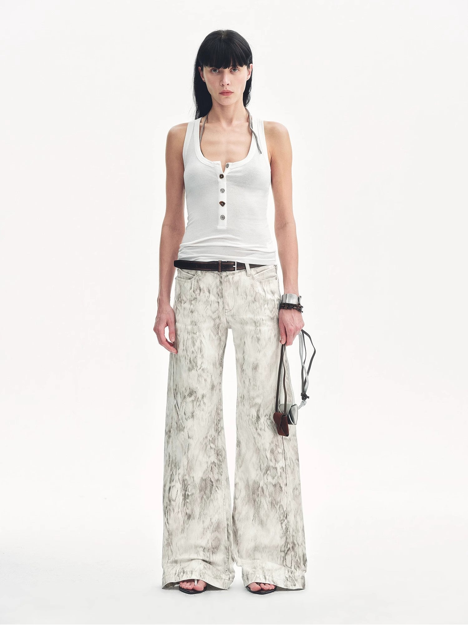 Brown Coeus Phantom snake print flared denim trousers with a stylish, fitted design and distinctive snake pattern.