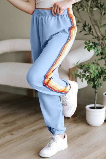 Light blue Carmine Juneberry rainbows high waist sweatpants with a relaxed fit and elastic waistband, designed for comfort.