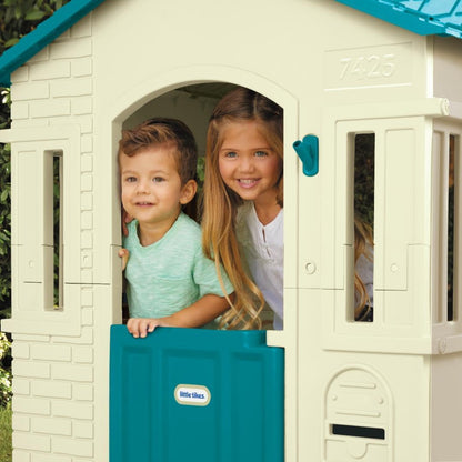 Large outdoor Blue Cape Cottage playhouse by Peach Maple, featuring windows and door, perfect for kids&