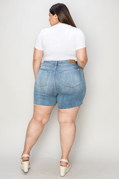 Judy Blue high waist raw hem denim shorts in full size, showcasing classic blue denim with distressed details and frayed edges.