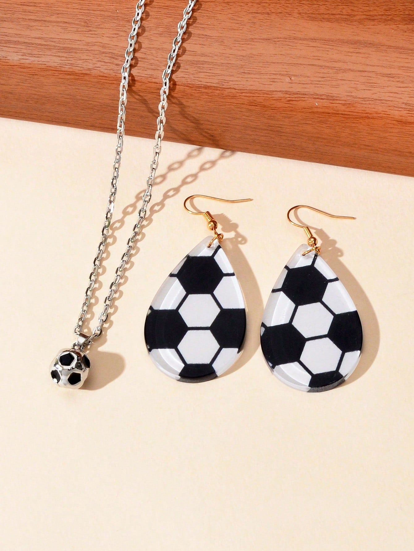 White Demeter sporty soccer pendant necklace and earrings set featuring soccer ball charms in silver-tone jewelry.