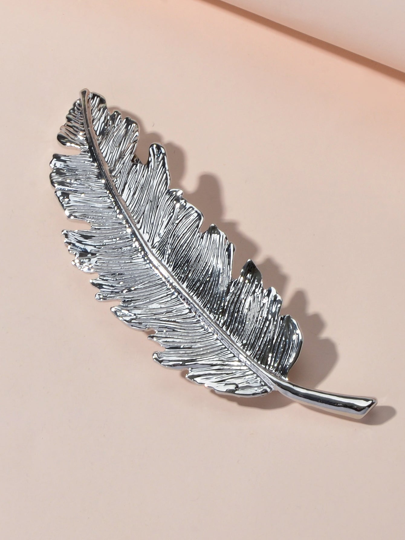 Gold and silver feather metal hair clips by White Demeter, stylish hair accessories for elegant hair styling.
