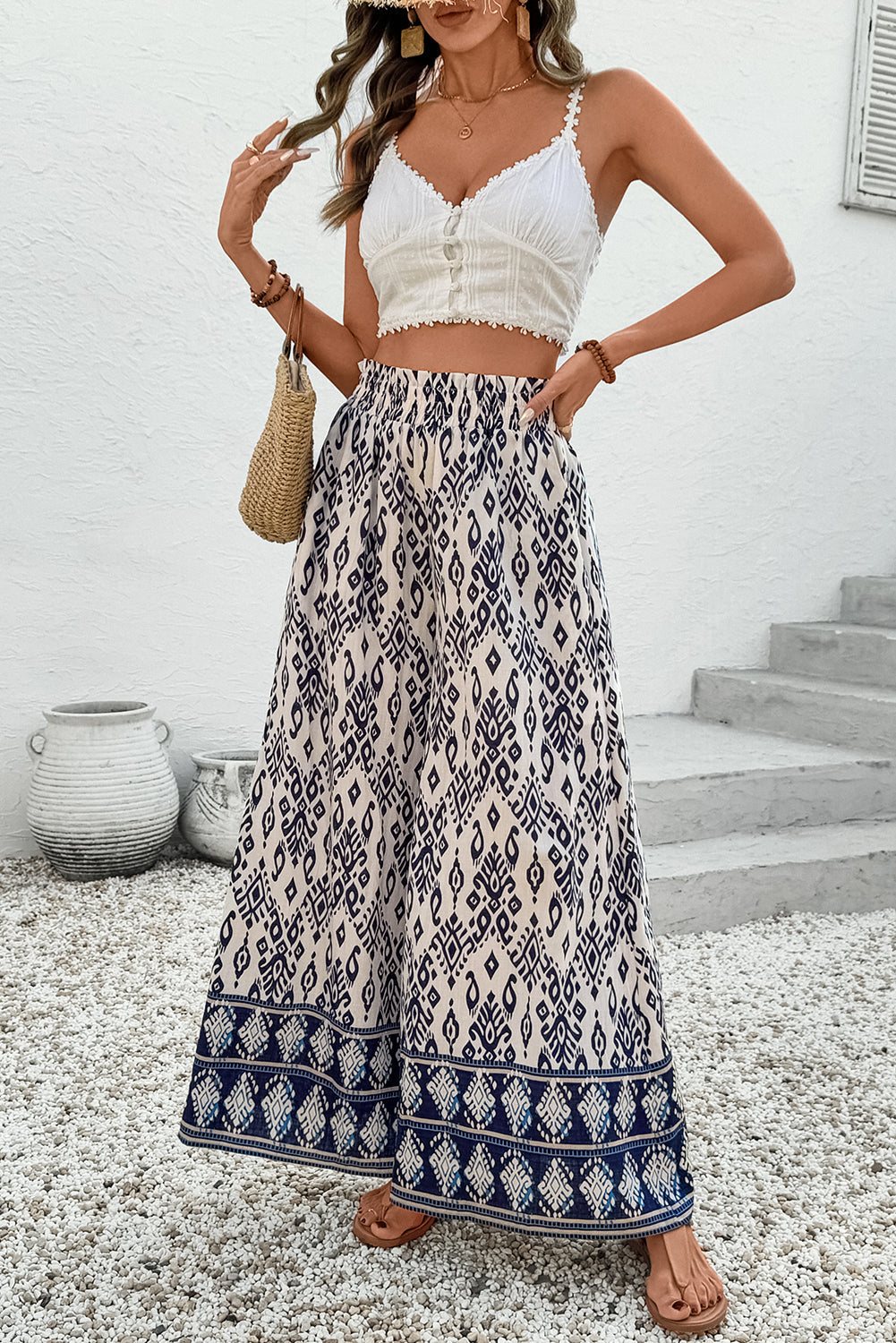 Women’s boho smocked high waist wide-leg pants by Byzantium Bay, featuring relaxed fit and flowy fabric in natural tones.