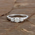 Sterling silver white moissanite 3-stone ring showing three sparkling stones set in a sleek band, elegant jewelry design