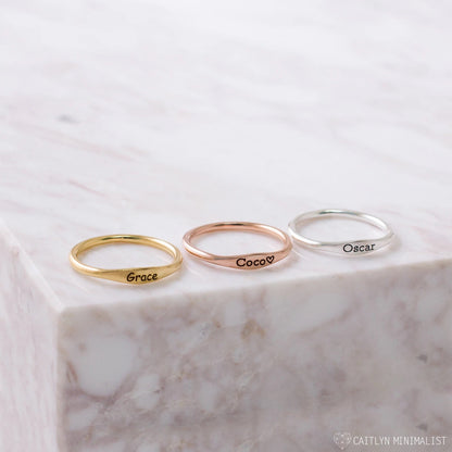 Delicate pink gold Tiny Name Ring by Pink Lucky, minimalist jewelry with a subtle engraved name on a slim band.