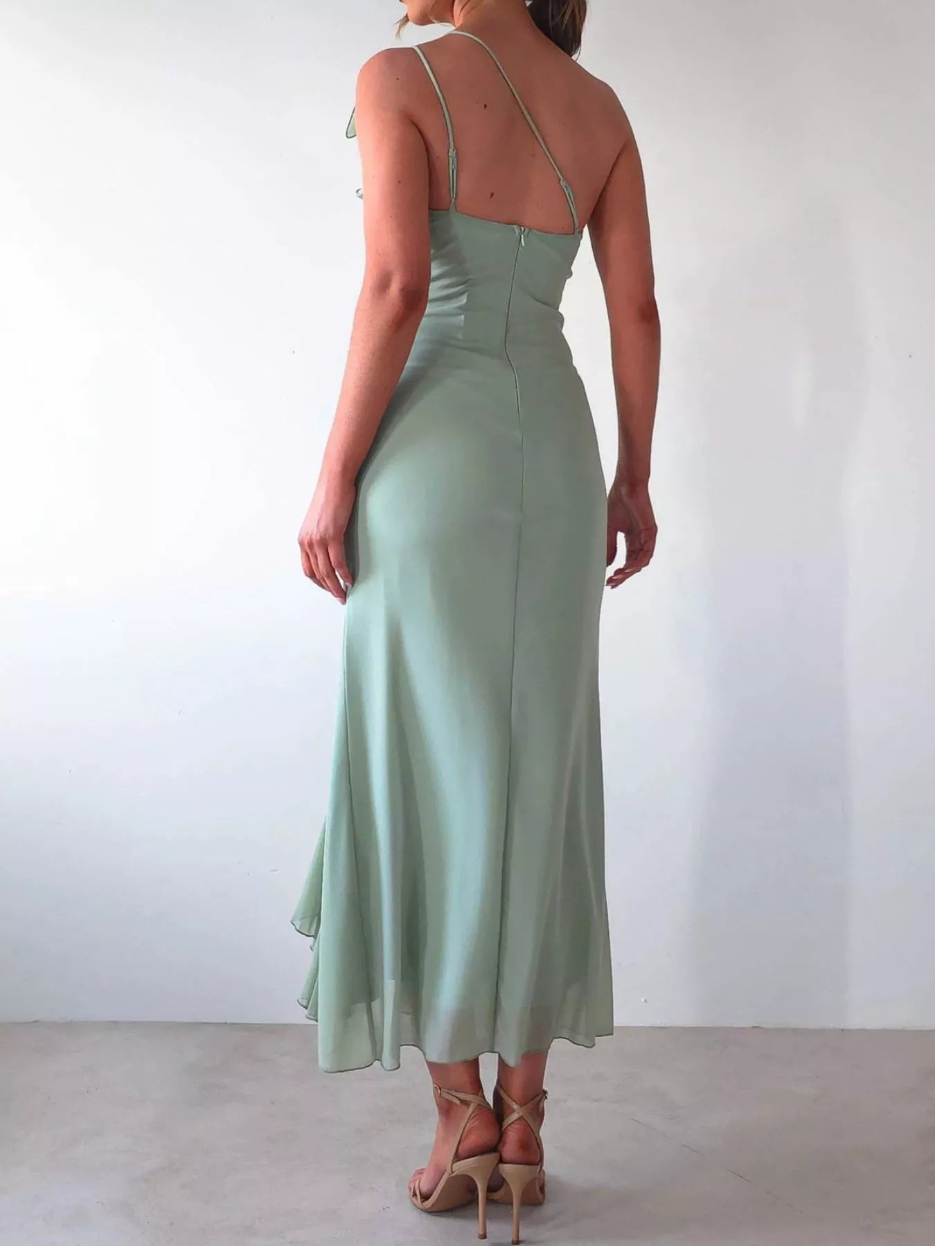 Jade Iapetus stylish one-shoulder ruffle slit dress displayed on a model, featuring elegant draping and a high slit design.