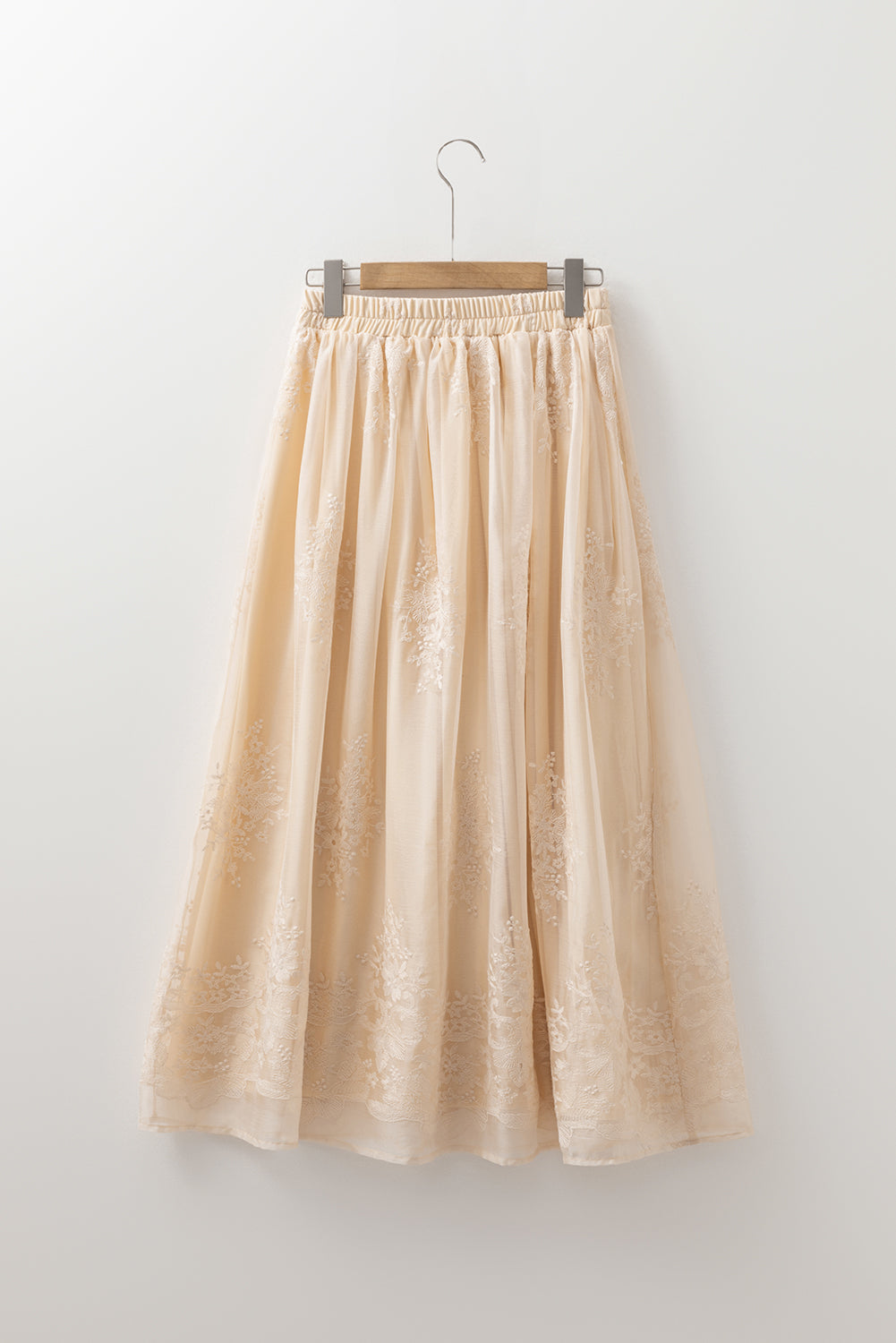 Solid embroidered mesh overlay midi skirt for women by Byzantium Bay, featuring intricate embroidery and flowing fabric.