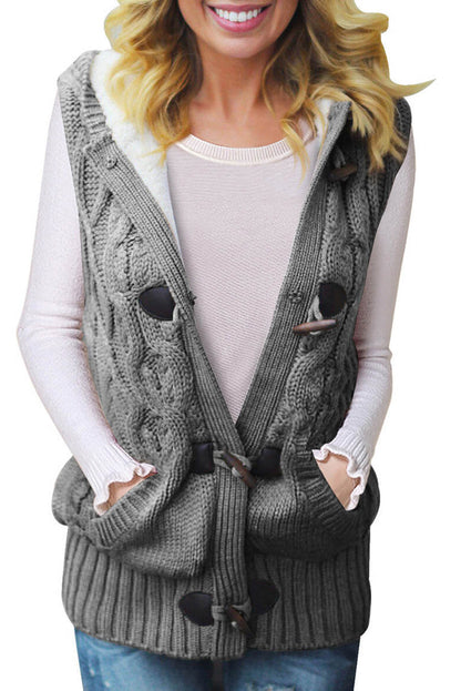 Multicolour cable knit hooded sweater vest by Harlequin Daisy, featuring a cozy, textured knit with a hood and multicolour pattern.