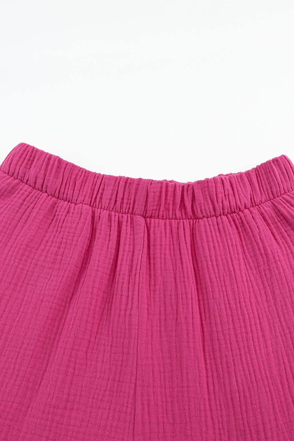 Rose textured high waist ruffled bell bottom pants by Carmine Juneberry, showcasing the floral fabric and stylish flared design.