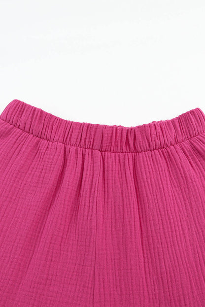 Rose textured high waist ruffled bell bottom pants by Carmine Juneberry, showcasing the floral fabric and stylish flared design.