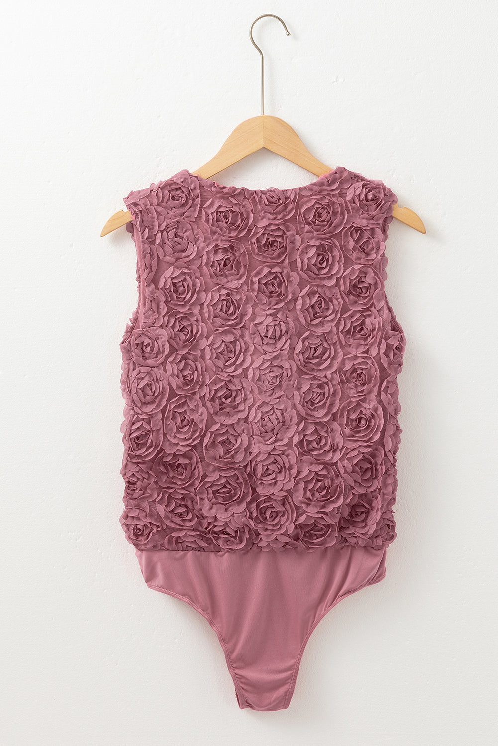 Floral textured V-neck sleeveless bodysuit by Byzantium Bay, featuring a wrapped design and fitted silhouette.