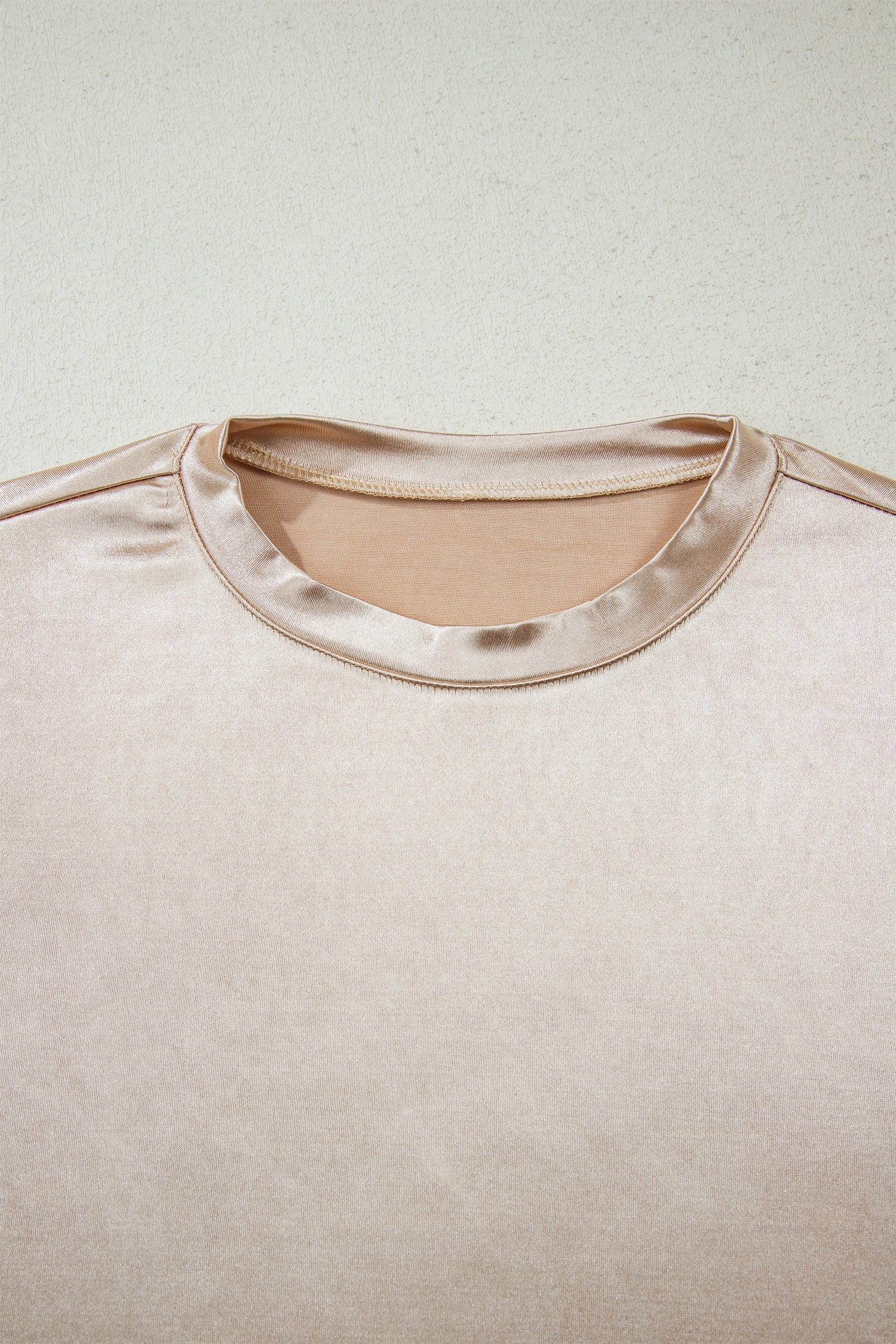 Metallic round neck tank top by Byzantium Bay, close-up view of the shiny, sleeveless top with a round neckline.