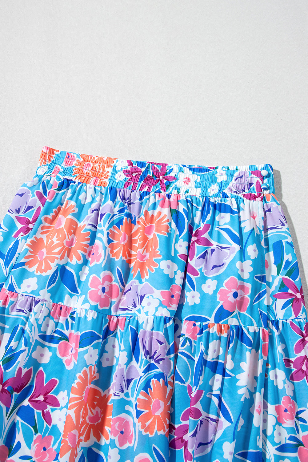 Floral high waist side split wrap maxi skirt by Byzantium Bay, flowing fabric with vibrant floral pattern and elegant design