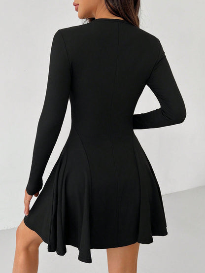 Green Alcestis dress with a flowing fabric and elegant design, showcased on a hanger against a neutral background.