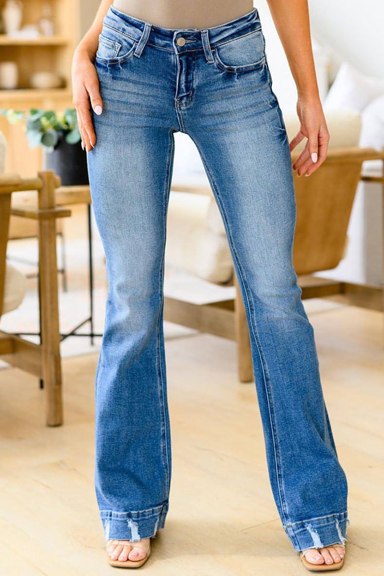 Light-colored high waist denim jeans for women by Carmine Juneberry, featuring classic denim texture and a fitted silhouette.
