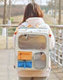 Pear Daisy rolling pet carrier with telescopic handle, designed for easy transport of small pets in home and garden settings.